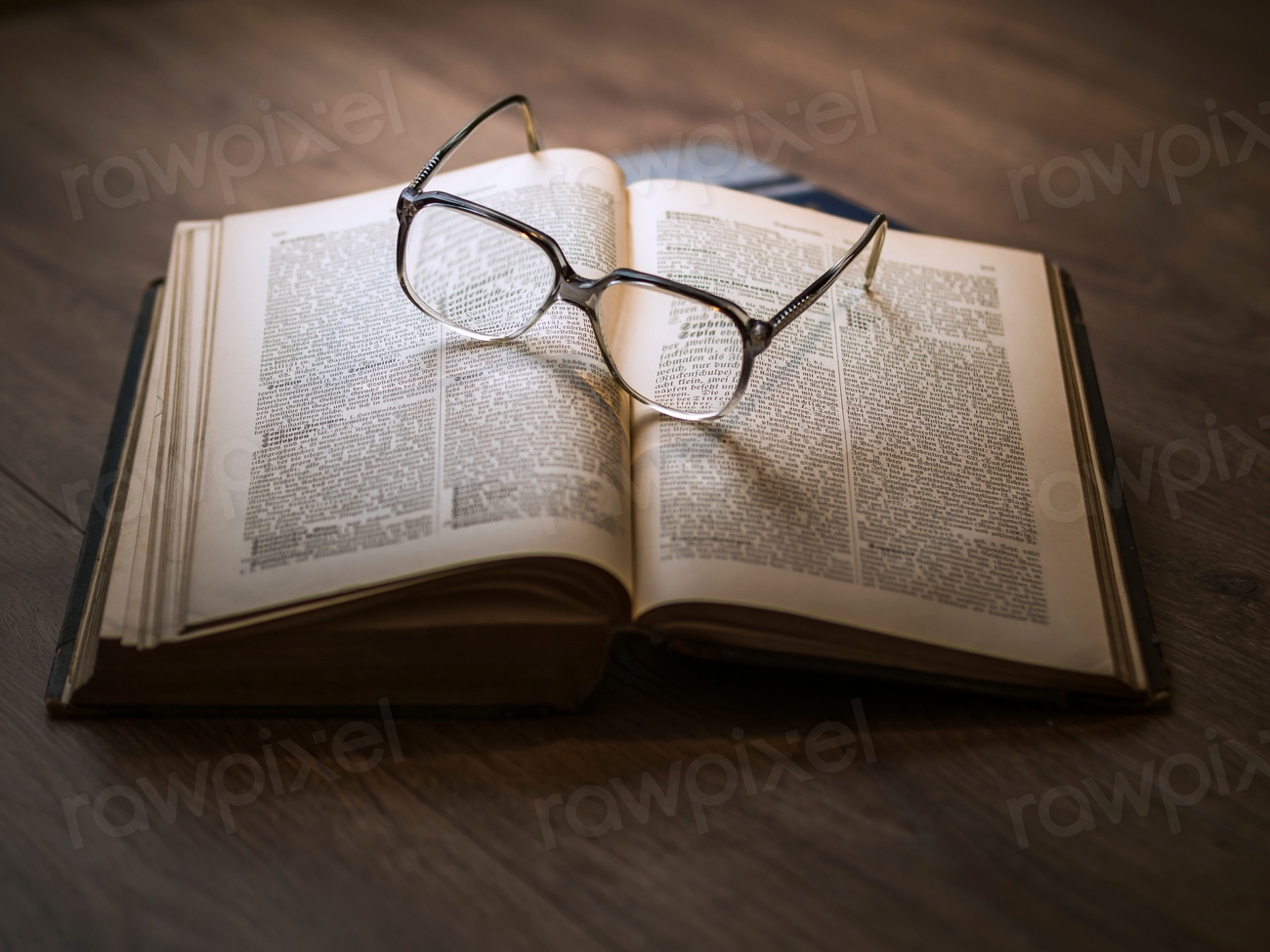 Framed eyeglasses top open book
